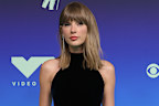 Taylor Swift wore a sparkling Tamara Ralph gown for the occasion. 