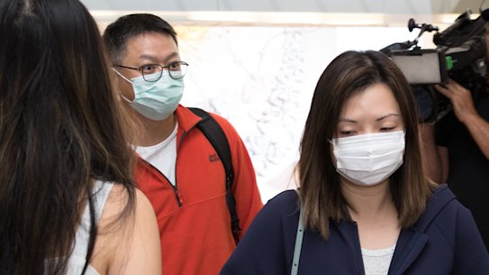 Passengers arrive at Sydney Airport from Wuhan wearing masks.