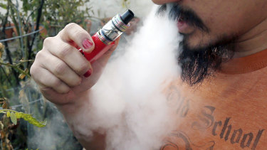 A man vapes with an e-cigarette. Authorities in the US think they have found at least one culprit causing lung illnesses associated with vaping.