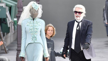 Adut Akech Bior closing the Chanel haute couture show with designer Karl Lagerfeld and his godson Hudson Kroenig in Paris on July 3. She is only the second black model to do so.