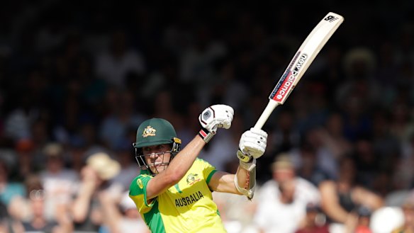Handy with the bat: Cummins hits a boundary off the bowling of New Zealand's Lockie Ferguson.
