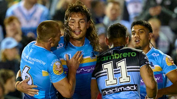 Tino Fa’asuamaleaui celebrates a try for the Titans on Friday night after signing the richest deal in rugby league history.