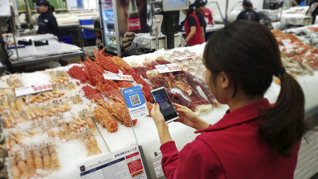 Shoppers use Alipay at Nicholas Seafood to place their order and pay from their phones. 