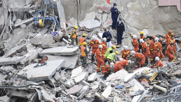 Rescuers search for victims at the site of a hotel collapse in Quanzhou, China, on Sunday.
