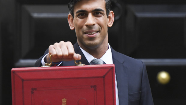 Suitcases of cash ... British Chancellor Rishi Sunak with the traditional red box.