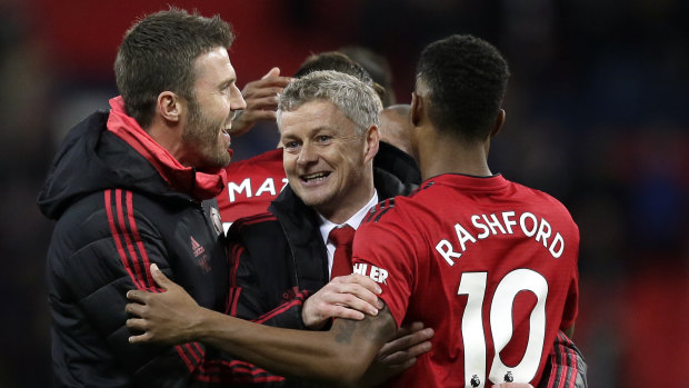 Major hurdle: Ole Gunnar Solskjaer (centre) celebrates after passing what was considered his first significant test as caretaker manager.