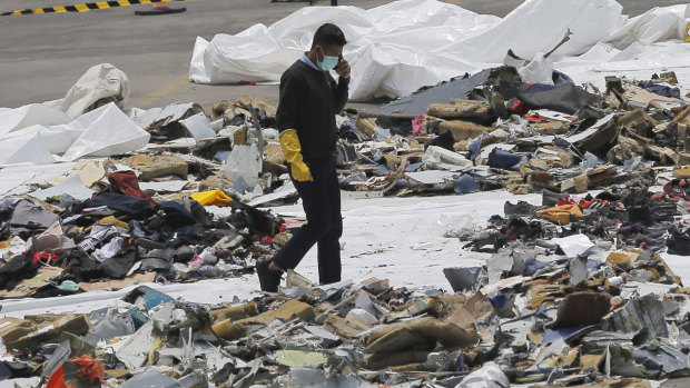 An investigator walks amid debris of Lion Air Flight 610 retrieved from the waters off Tanjung Priok in Jakarta.