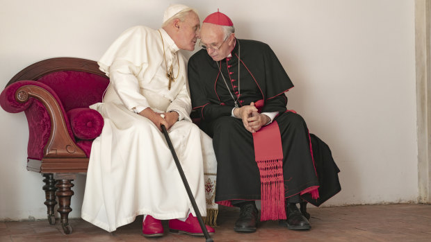 Jonathan Pryce as Cardinal Bergoglio, right, and Anthony Hopkins as Pope Benedict in a scene from The Two Popes. 