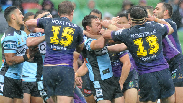 Dust-up: Cronulla and Melbourne players go at it last year.