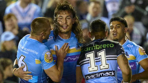 Tino Fa’asuamaleaui celebrates a try for the Titans on Friday night after signing the richest deal in rugby league history.