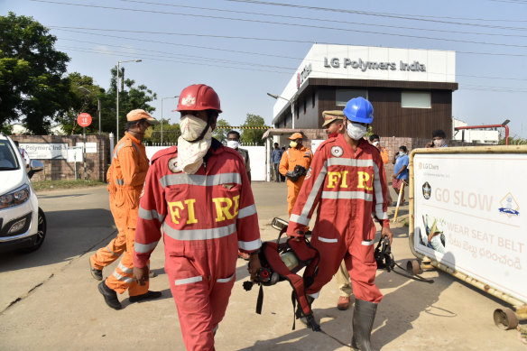 Firefighters walk with oxygen cylinders outside LG Polymers plant, the site of a chemical gas leak, in Vishakhapatnam, India, last week. 