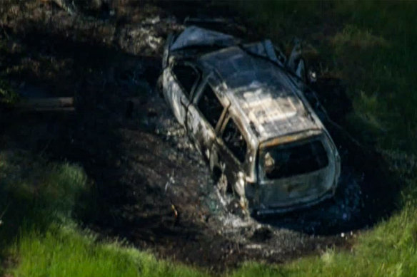 The burnt-out shell of what appeared to be a Kia Carnival.