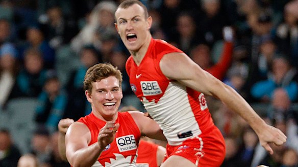 Angus Sheldrick and Chad Warner of the Swans celebrate a goal.
