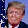 US President Donald Trump hugs the American flag as he arrives to speak at Conservative Political Action Conference in Maryland. 