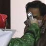 Authorities search door-to-door for coronavirus in Wuhan as cases fall