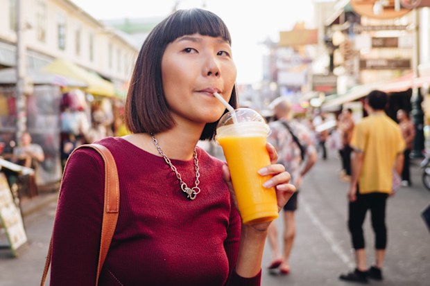 Stock image of a woman drinking orange juice