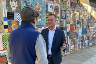 Tim Wilson pressing the flesh with commuters on Wednesday.