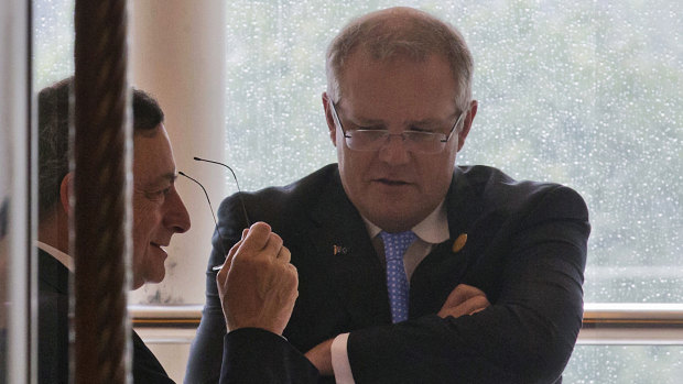 Then president of the European Central Bank, Mario Draghi, left, and Prime Minister Scott Morrison, then treasurer, chat during the G20 Finance Ministers meeting in Chengdu, China, in 2016.