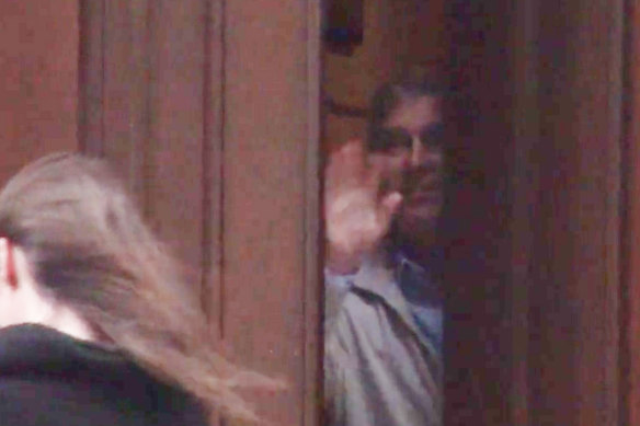 Prince Andrew appears to wave goodbye to a woman in the video.