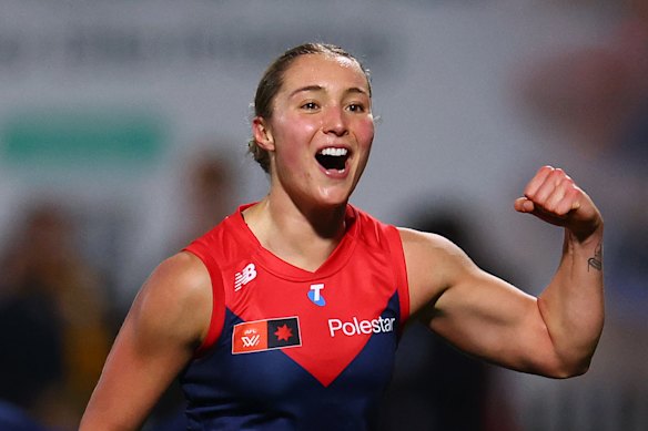 Mia Austin of the Demons celebrates kicking a goal.