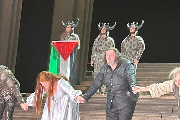 A photo posted on X showing a cast member at the Royal Opera House in London holding a Palestinian flag during a curtain call. 