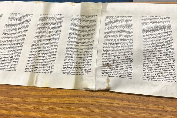 Torah scrolls with water damage caused during the arson attack.