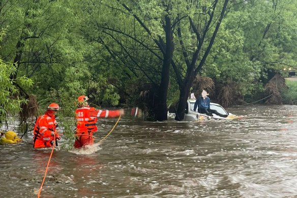 A man is rescued from a four-wheel drive wagon in Yass, which ended up in a creek against a tree with water rising around it on Greenwood Road, Murrumbateman. 