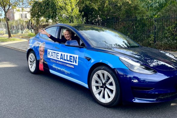 Katie Allen in her Tesla, specially branded for the campaign.