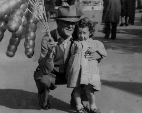 Marjorie Chant as a toddler at 1950 Melbourne Royal Show with balloon seller Digger McCarthy.