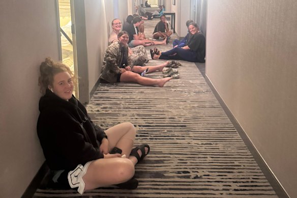 Wallaroos players sheltering in a hallway of their hotel in Kansas City.