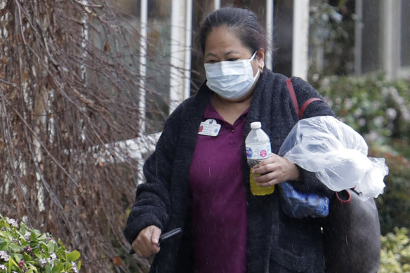 A masked worker at the Life Care Centre in Kirkland, Washington, where several residents of the facility have died as a result of the COVID-19 disease.