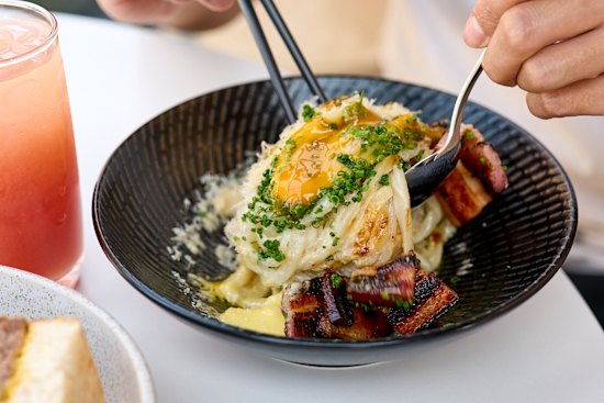 Udon carbonara with charred kaiserfleisch, a soft egg and pepper. 