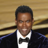 Chris Rock on stage presenting the award for best documentary feature at the 2022 Oscars.