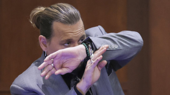 Actor Johnny Depp demonstrates how he claims to have shielded himself from an alleged attack by his ex-wife Amber Heard.