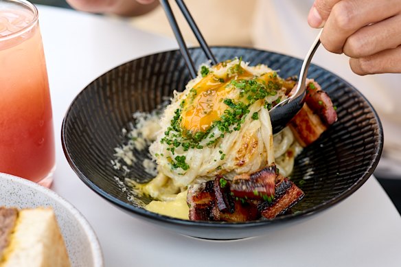 Udon carbonara with charred kaiserfleisch, a soft egg and pepper. 