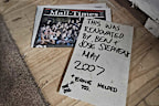 The newspaper and plasterboard message found by Maddi and Josh King.