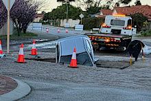 A burst water main is reportedly the cause of the massive sinkhole.