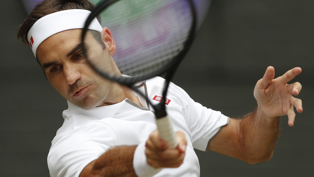 Roger Federer returns the ball to Novak Djokovic during their Wimbledon final on Sunday.