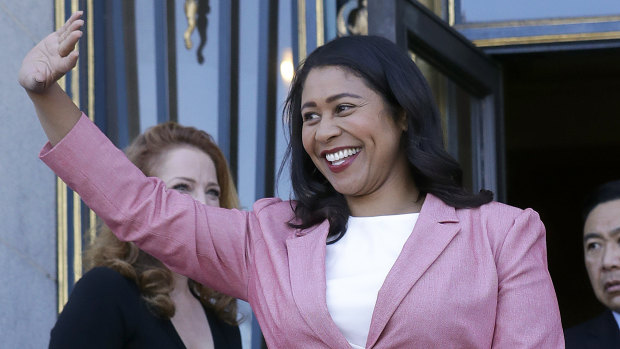 London Breed waves outside of City Hall in San Francisco after the result.