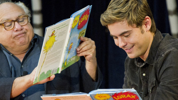 Danny DeVito and Zac Efron read ‘The Lorax’ to school children at American book week in 2012.