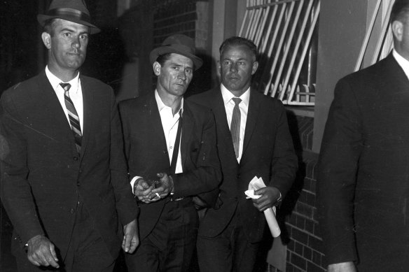 Melbourne prison escapee Ronald Ryan being taken to police headquarters in Sydney after his recapture on January 5, 1966. He was executed in 1967.