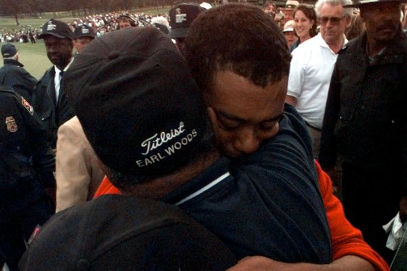 Tiger Woods celebrates his record-breaking 1997 Masters win with his father Earl.
