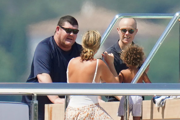 A bulkier James Packer with friends on his yacht in St Tropez in July last year.