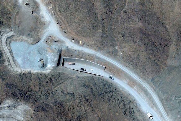 A satellite image shows vehicles at the western tunnel entrance to Iran’s secretive Pickaxe Mountain complex.