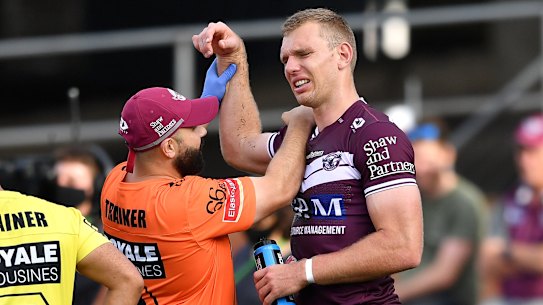 Tom Trbojevic grimaces while having his shoulder assessed after injuring it against the Titans.