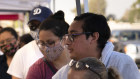 People receive groceries at a food bank in California. Economic fallout from the pandemic has hit many hard.