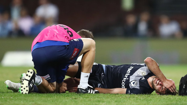 Down and out: Terry Antonis receives attention from Victory medical staff after suffering a knee injury at the SCG on Saturday night.