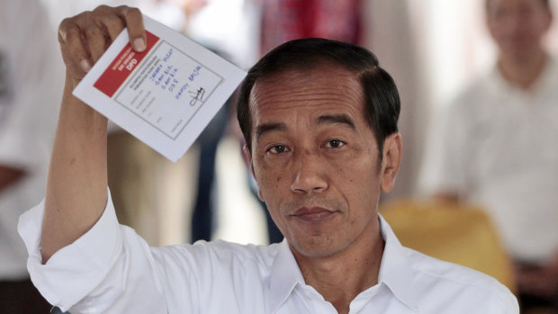 Joko Widodo prepares to cast his ballot in the Indonesian election.