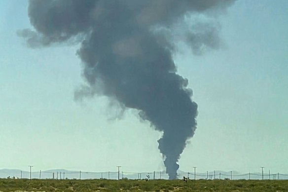 Smoke rises after the crash. 