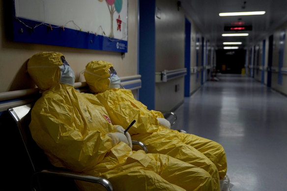 Exhausted frontline health workers take a breather in a hospital corridor in Wuhan in a scene from the documentary 76 Days.